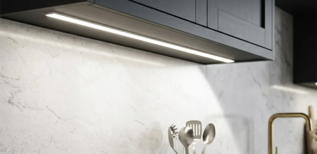 LED under-cabinet lighting illuminating a white marble backsplash.