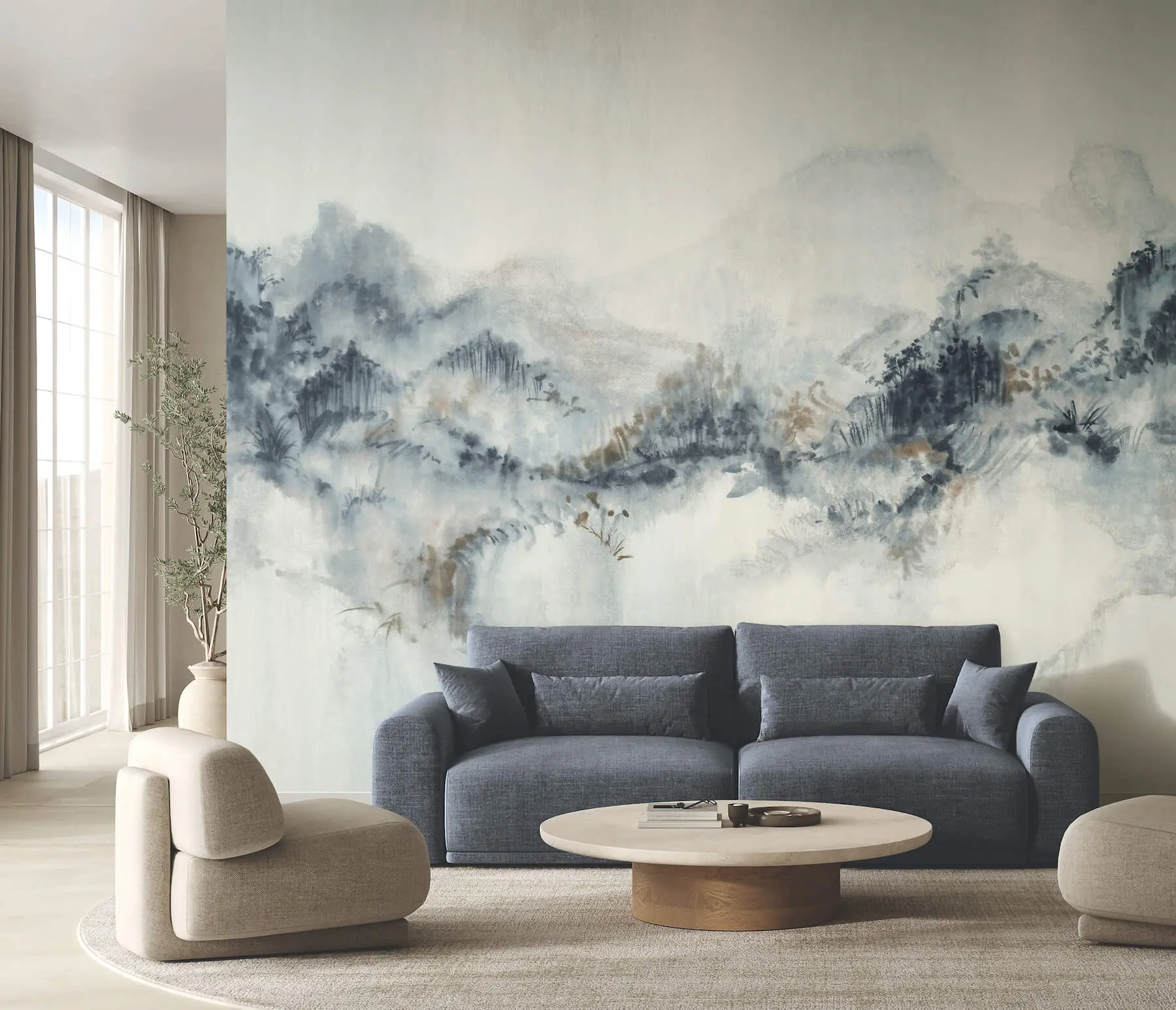 A modern living room featuring a large wall mural with a soft, watercolor-style blue and grey mountain landscape behind a dark grey sofa.